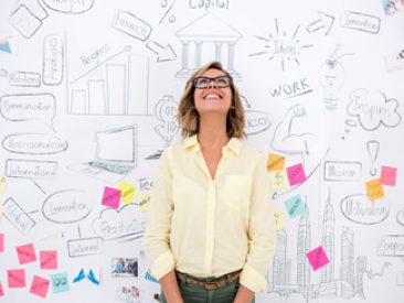 Creative business woman thinking and brainstorming with a wall chart at the background